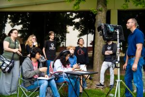 Oklahoma City Community College Digital Cinema students participate in an outdoor film production class, operating professional camera equipment alongside an instructor.