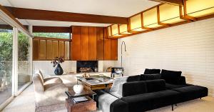Living room of a mid-century house with copper clad fireplace and bespoke light fixture.