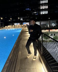 Martyn Kingsley, professionally known as MartynGBuckets, of MGBSP Services, standing beside a rooftop pool at night.