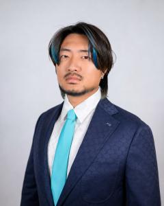 Portrait of Kaixiong Zhang, founder of Secret World app, wearing a navy suit and turquoise tie.