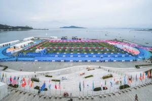 Waterfront triathlon venue in Weihai with international flags
