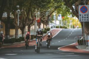 Triathletes cycling through an urban course in Weihai