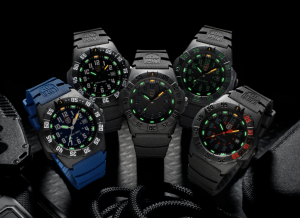 Five Luminox Navy SEAL 3550 watches with glowing Luminox Light Technology, arranged with tactical gear against a dark background.