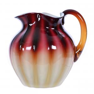 This plated amberina art glass water pitcher by New England, 7¼ inches tall with exceptional color and condition, from the collection of Douglas Milhoff of Ohio, sold for $5,750.