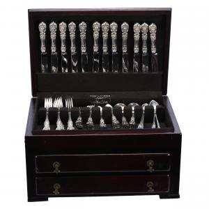 100-piece sterling silver flatware set by Reed and Barton in the Francis I pattern, in a silver chest with lid and two drawers. The solid sterling items weighed 3750 grams. Sold for $9,200.
