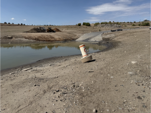 A “No Wake” buoy sits stranded on the exposed lakebed at Elephant Butte Reservoir in New Mexico as crews work near a boat ramp in August 2026.