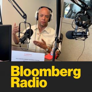 A picture of a man being interviewed in a radio booth.