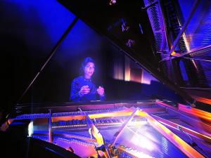 Composer and pianist Nicole Brancato performing at a grand piano during the recording of "Home (Aramaic)."