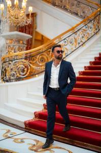 Amir Davidson, CEO of Davidson Real Estate, on the grand staircase of Bat Sheba's Palace, a luxury estate in Caesarea, Israel.
