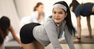 Participant practicing a controlled Pilates movement during the MOVE INTO YOUR FUTURE SELF experience.