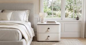 Ivory two-drawer Milan nightstand with leather loop handles.