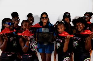 Cynthia Cureton-Robles with East Point Girls Flag Football athletes with TRONUS Recovery Slides™