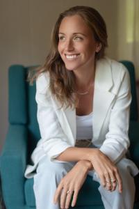 A woman sitting while smiling