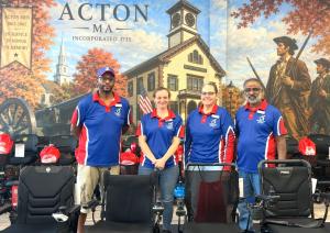 Photo of Owners & Team in the Showroom in front of Mobility City of Acton Mural