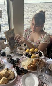 Guest pouring tea while sailing aboard the Jane Austen Themed High Tea Aboard the Barbara-Lee Rivership in Sanford, Florida