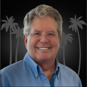 A photo of Pat in a Blue collared shirt with a black background with gray palm trees behind him