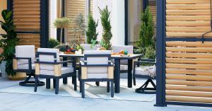 Mirador Siena 7-Piece Dining Set with six cushioned seats and swivel captain’s chairs arranged beneath a pergola for outdoor dining and gatherings.