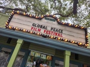 Marquee sign outside Enzian Theater in Maitland, Florida, illuminated with lights and displaying the words “Global Peace Film Festival” above the theater entrance.