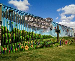 Artistic mural of cross on side of building
