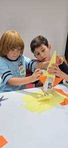 Students building a rocket together during a hands-on engineering activity at the Mind Base Education STEM Summer Program in Abu Dhabi.