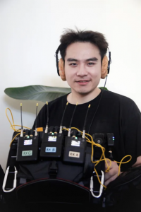 Peter Zongting Li on location, running wireless audio for production sound.