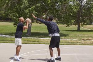 Imari & Spencer playing basketball at their favorite park