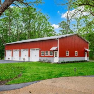 an exterior of a red 30x60x16 metal shop building with 4 garage doors