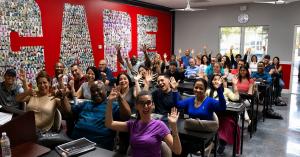 Cameron Academy of Real Estate students raising their hands during a Florida real estate licensing class