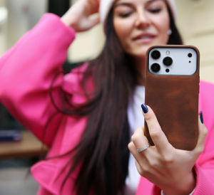 Woman holding an iPhone 18 Pro with a brown O2 Leather leather case.