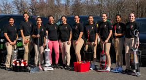 Professional cleaning team with branded cleaning vehicles and equipment representing the operating experience behind CleanBucks.