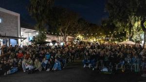 Audience watching an outdoor film screening on Forest Avenue in Laguna Beach during the Coast Film & Music Festival
