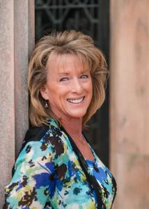 Lisa Wise, founder of Step-by-Step Wellness, smiling outdoors