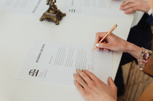 Client signing divorce paperwork with an attorney, representing legal guidance from a Divorce Attorney Lehi families trust