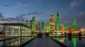 Twilight panoramic view of Riyadh's financial district illuminated in green and gold