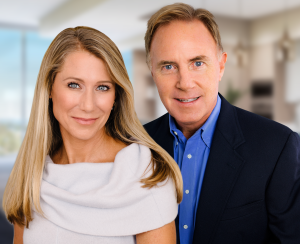 Studio headshot of Steve and Janet Walter, co-founders of Walter Group Real Estate, smiling against a softly blurred interior background.