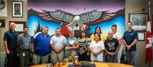 Representatives of Miranda Water Technologies and members of Curve Lake First Nation Council standing together at the Curve Lake First Nation Government Building.