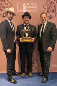 Jeff DuJardin (L) with ELKHORN exec producers Craig Miller (R) and Gary Tarpinian (C) on the red carpet holding their award at 2026 Western Heritage Awards