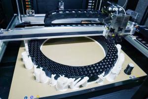 Image of large 3D printer in the process of creating a physical tire prototype.