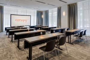 Downtown Boston meeting room in the classroom set-up with an A/V projection screen and floor-to-cieling windows.