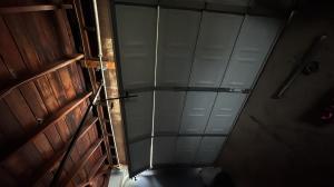 Emergency garage door repair Long Beach technician repairing a residential garage door