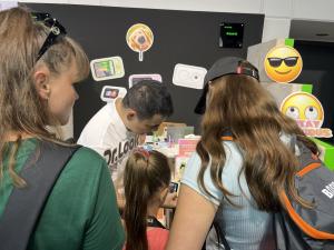 A child tries the Dr.Look Ai Learning Camera while family members watch at the Dr.Look Ai booth during IFA 2026.