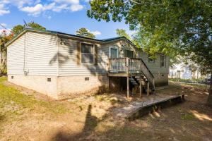 Situated on two lots (E58 & E59) totaling approximately 0.30 acres, this 1,196 +/ sf. doublewide offers a spacious floor plan featuring a large family room, 3 bedrooms, including a generous primary suite with private bath, heat pump for heating/cooling