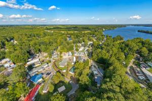 Situated on two lots (E58 & E59) totaling approximately 0.30 acres, this 1,196 +/ sf. doublewide offers a spacious floor plan featuring a large family room, 3 bedrooms, including a generous primary suite with private bath, heat pump for heating/cooling