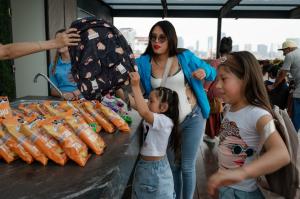 Surrogate's children receiving school supplies at the Foundation event in Mexico City