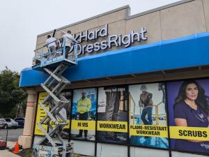 Exterior signage and window graphics installed by Feury Image Group at Work Hard Dress Right demonstrate how signage can identify a location, reinforce the brand and communicate key offerings to customers.