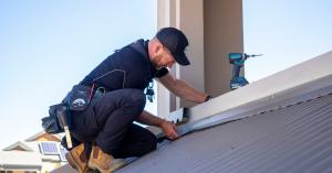 A tradesperson carries out roof maintenance ahead of the spring storm season.