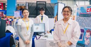 Members of Team CARED from the Philippines present their healthcare innovation project at a World Robot Olympiad event.