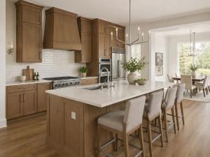 Kitchen remodel with warm wood shaker cabinets, oversized island, white subway tile backsplash, and pendant chandelier