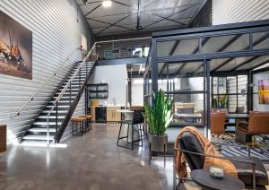 Custom office with stairs going up to a built out mezzanine