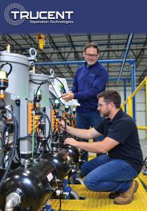 Two engineers examine piping, valves, and instrumentation on a Trucent industrial separation system.